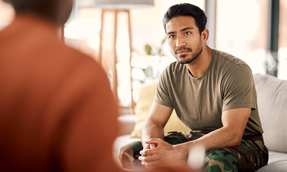 young adult in an in-person mental health meeting.